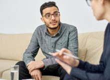Patient talks with treatment professional about opioid use.